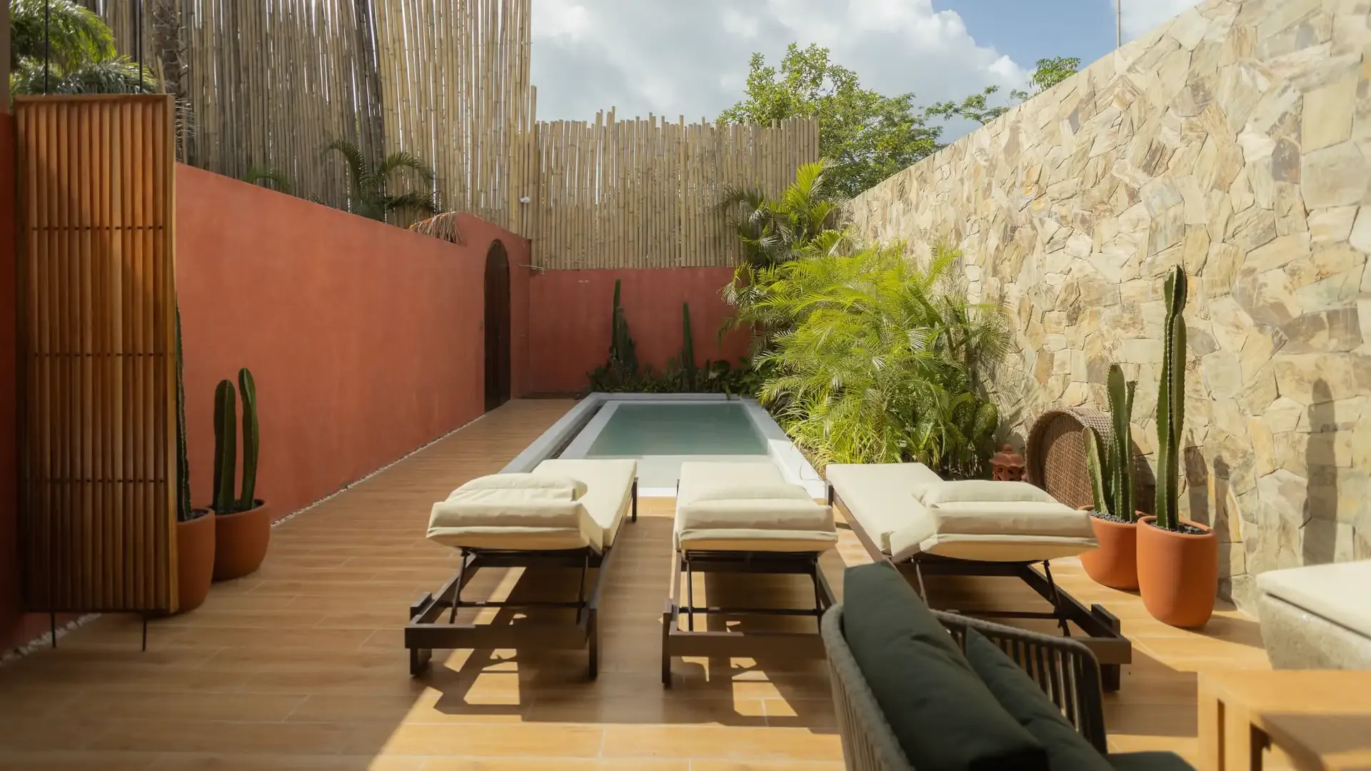 A private plunge pool and daybed framed by tropical greenery at a Lio Lio suite in El Nido, Palawan
