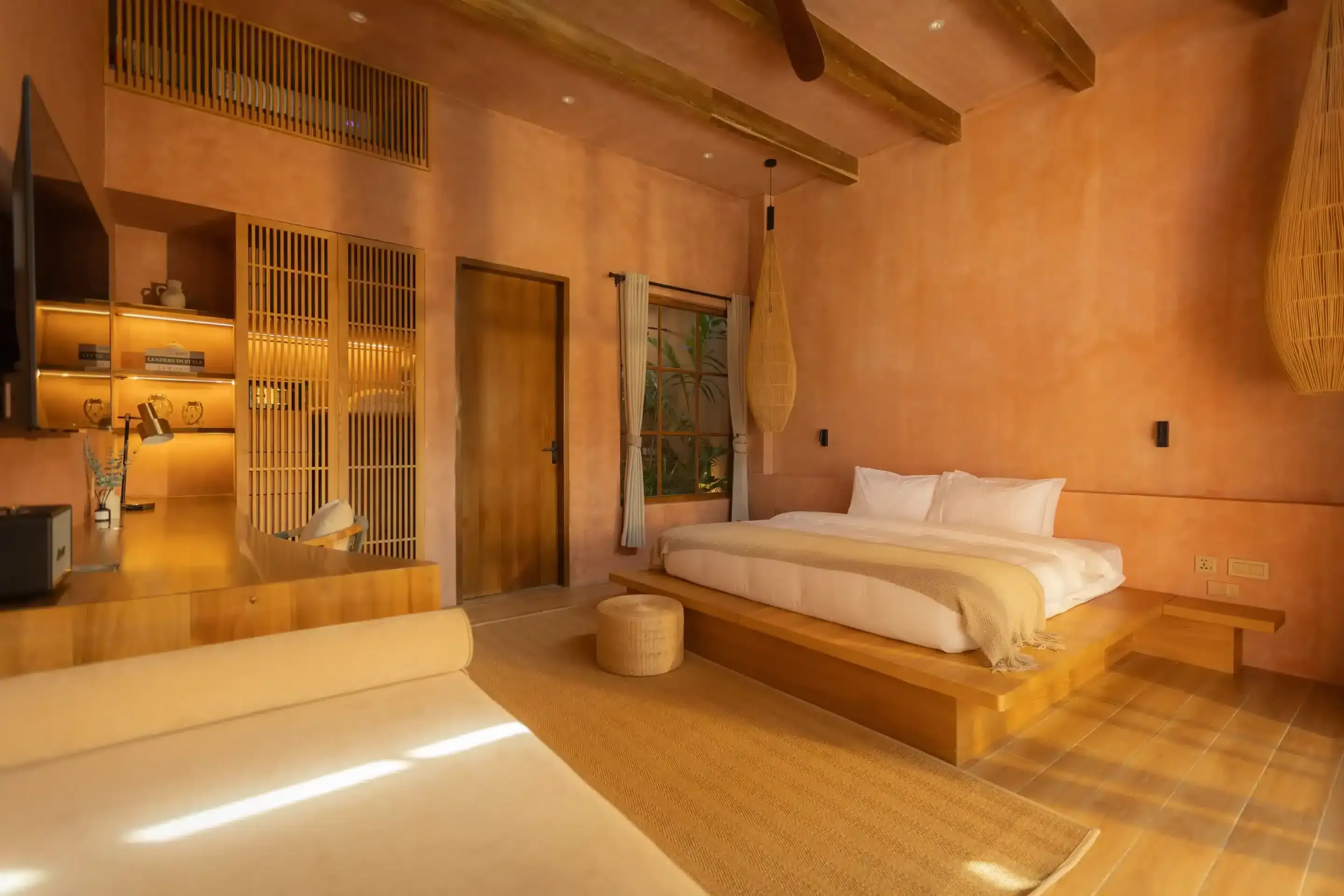 A warm, light-filled suite interior with natural wood and soft lighting at Lio Lio Suites, El Nido